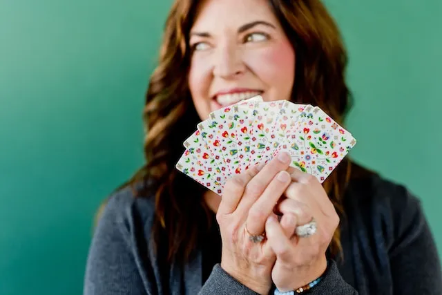 woman with ornate cards in hands