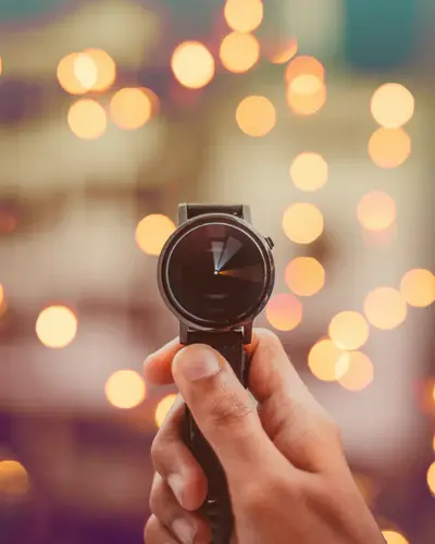 A person holding a wrist watch